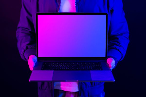 Businessman,Showing,Laptop,Blank,Screen,In,Neon,Light