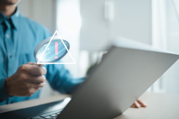 Cybersecurity,Analyst,Investigates,A,Digital,Warning,Alert,On,A,Laptop,