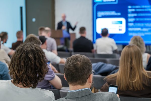 Business,Professionals,Attentively,Listening,To,A,Speaker,Presenting,During,A