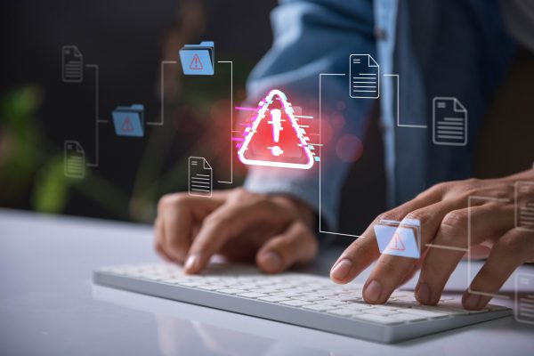Warning,Alert,Icon,With,A,Hacked,Document,System.hands,Typing,On