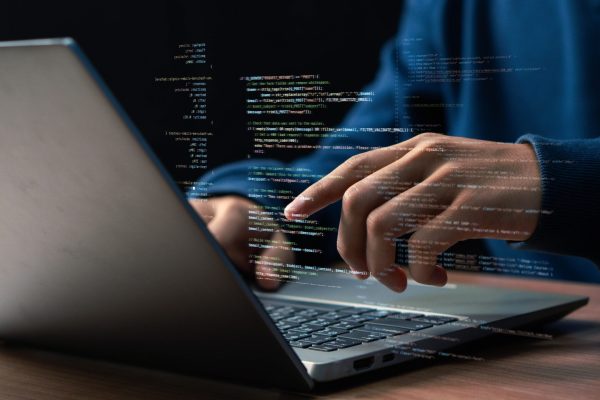Software,Development,Concept.,Hands,Typing,On,Laptop,With,Programming,Code