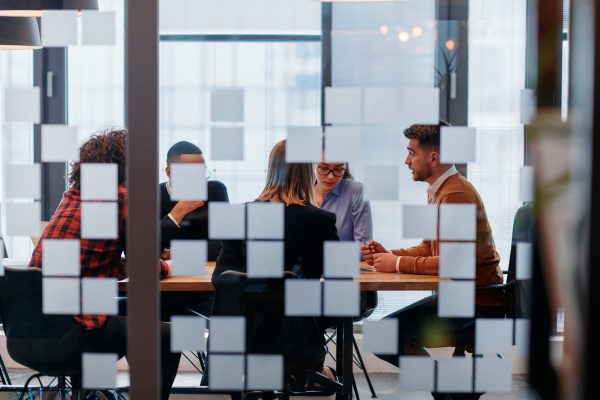 In,A,Sleek,Glass,Office,Space,,A,Team,Of,Business